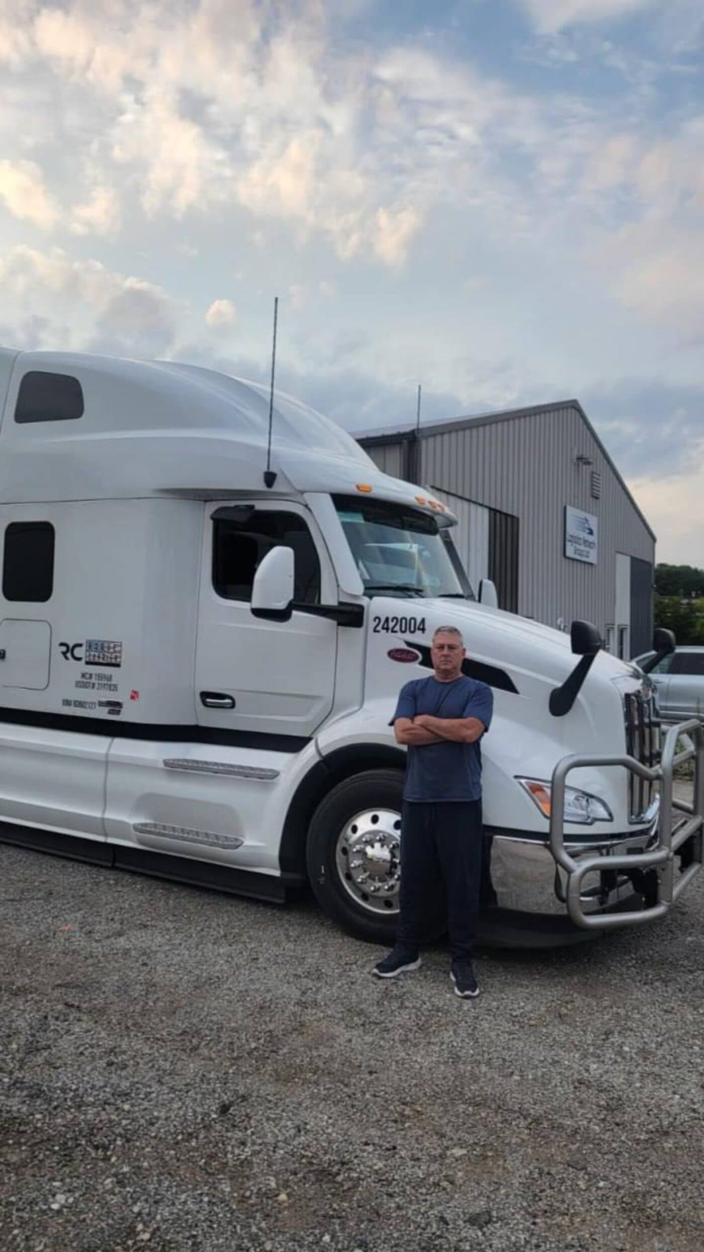 Driver standing by truck